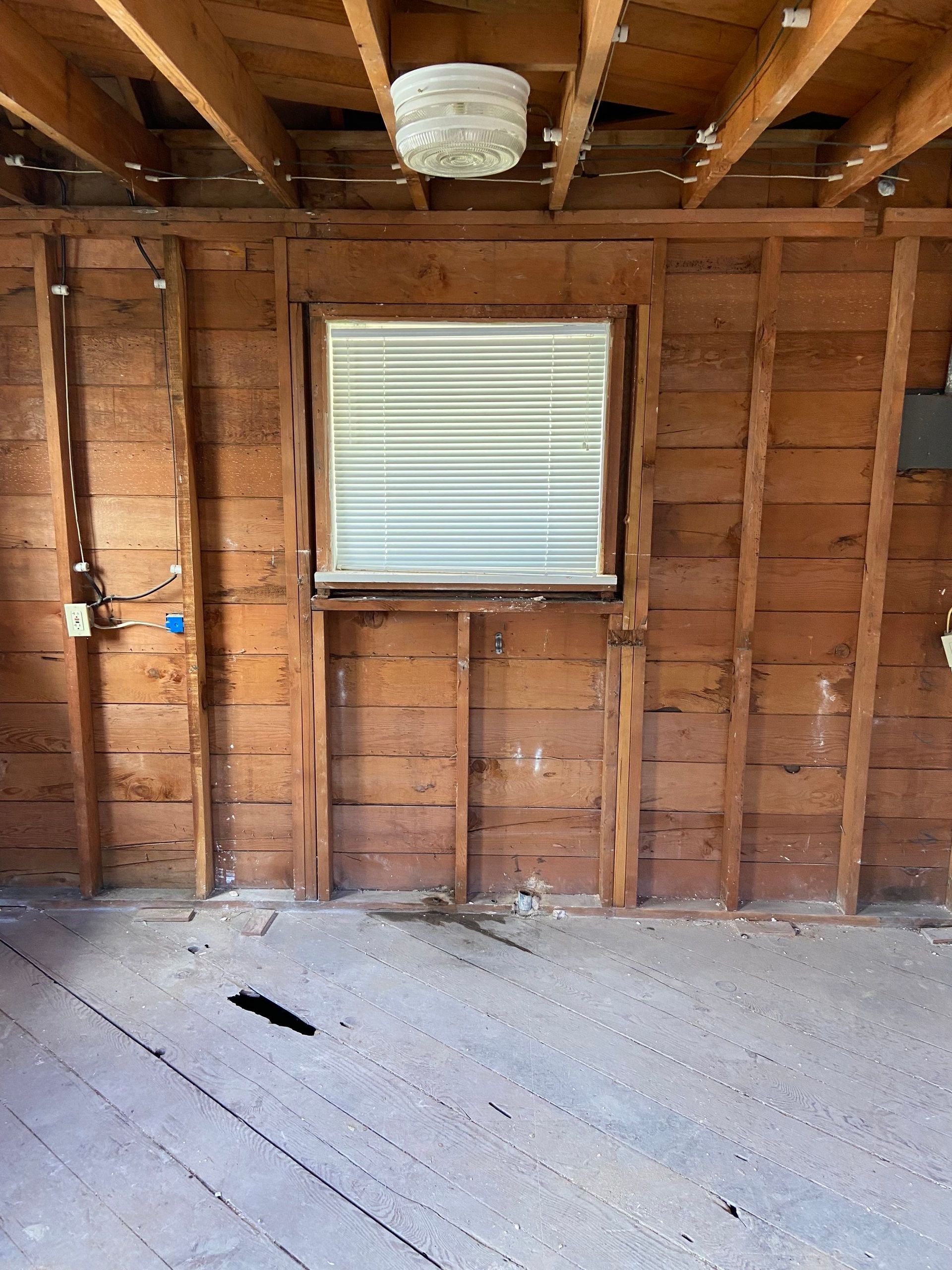 An empty room with a window in the wall.