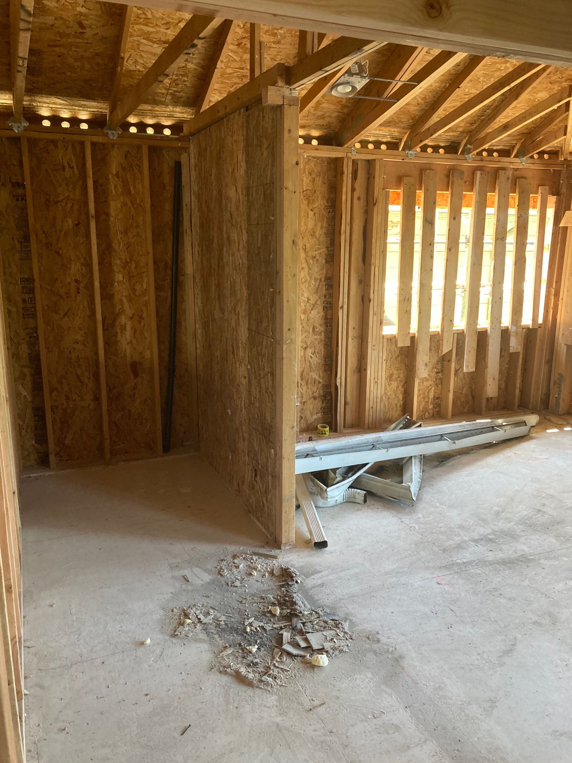 A room in a house under construction with a ladder on the floor.