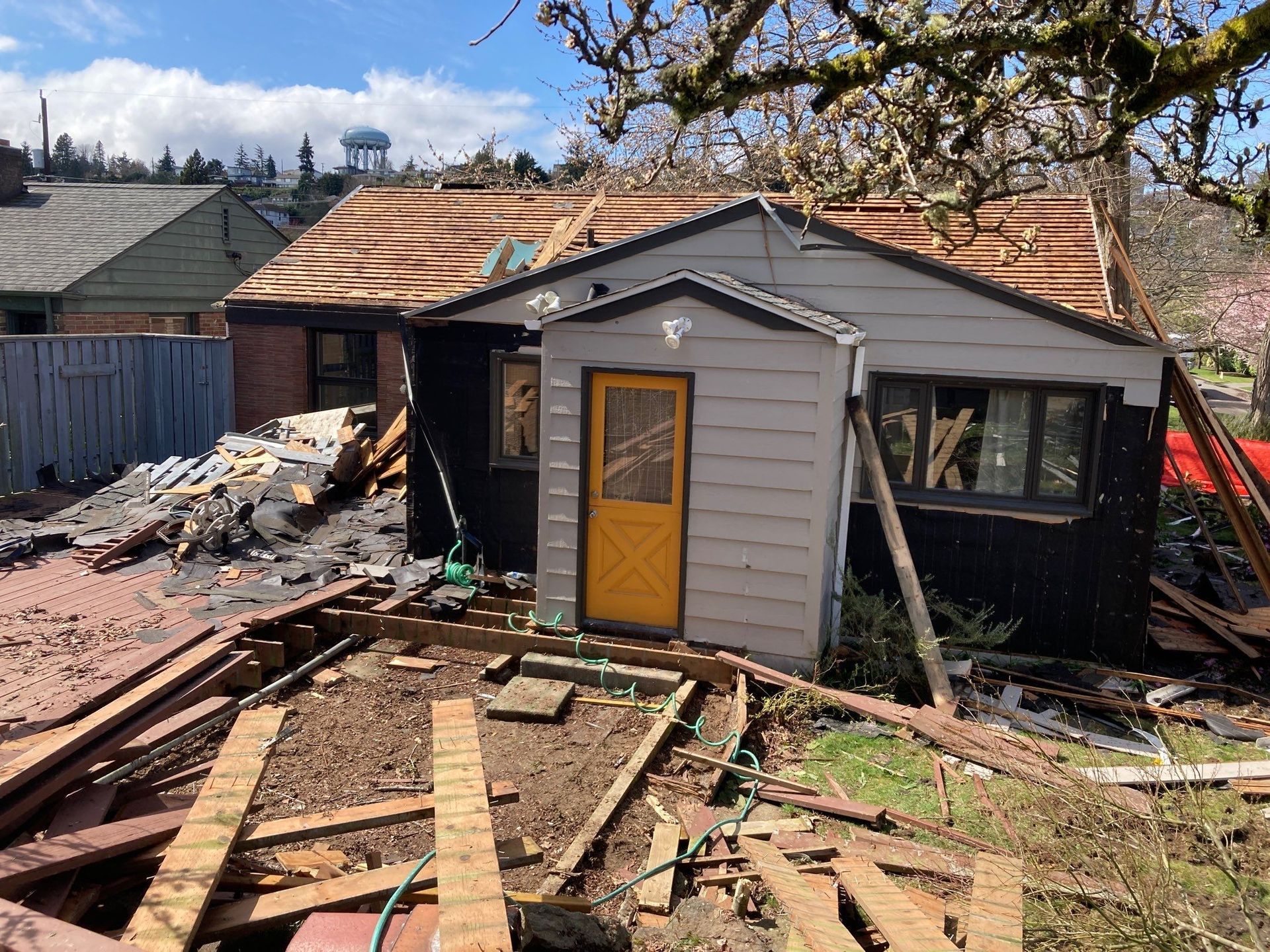 A house with a yellow door is being demolished.
