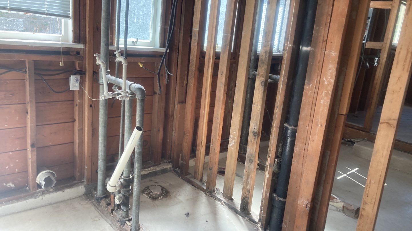 A room with wooden walls and pipes in it.