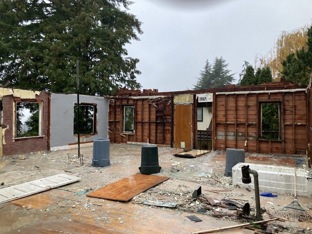 A house is being demolished in the middle of the day.