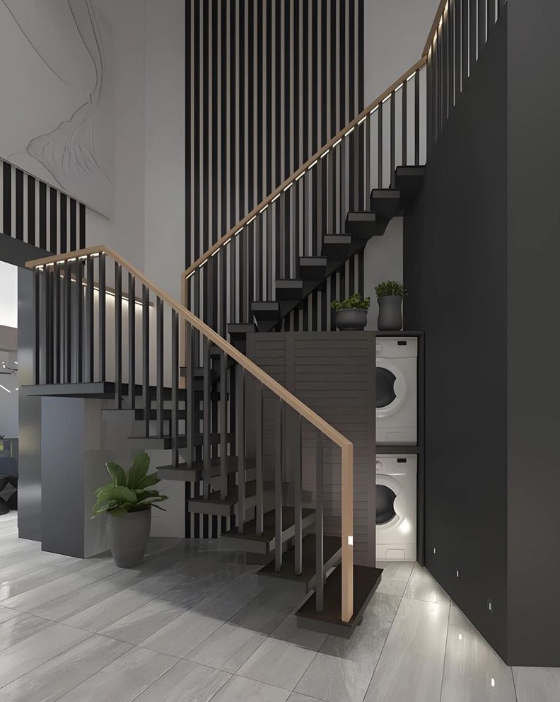 Un escalier dans une maison avec une laveuse et une sécheuse en dessous