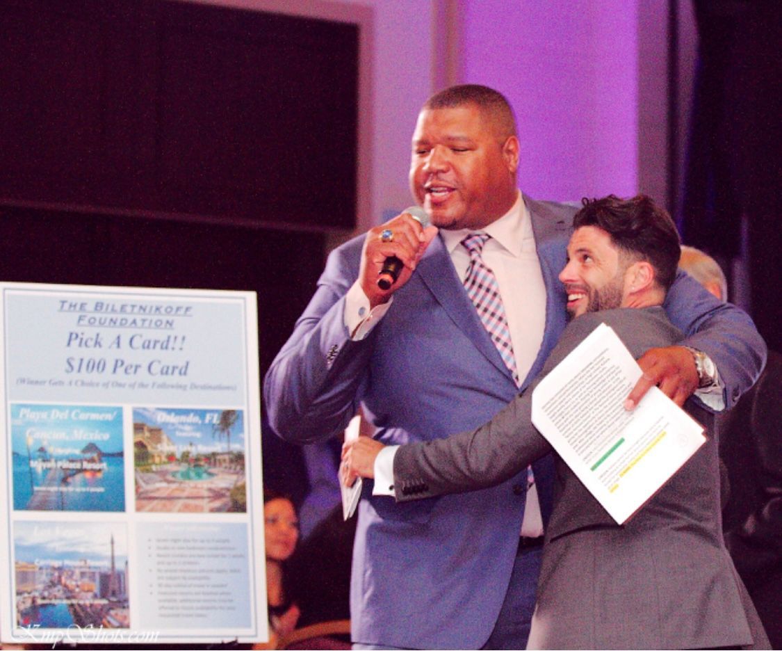 A man is hugging another man