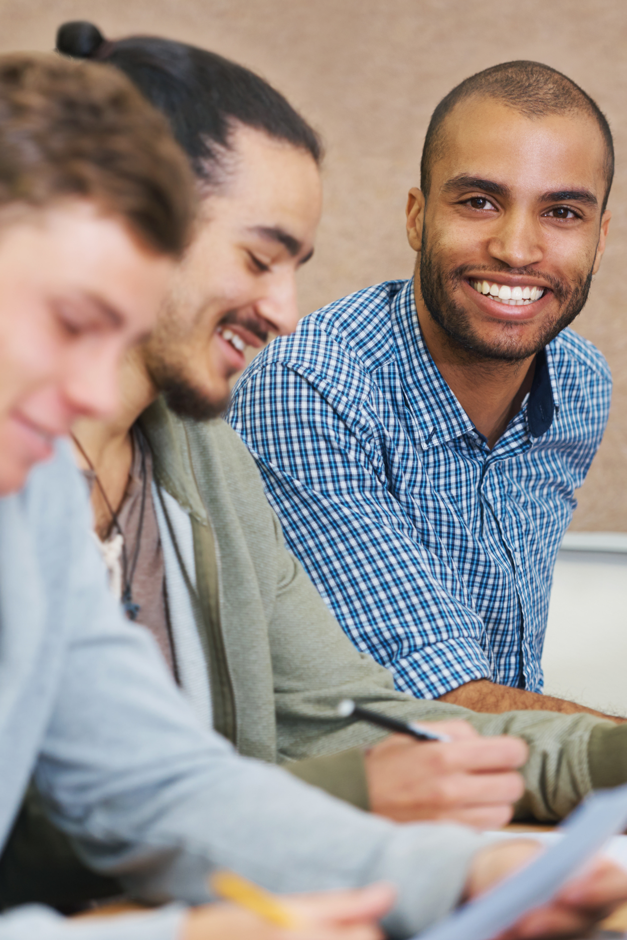 Young men studying with other DKE Members