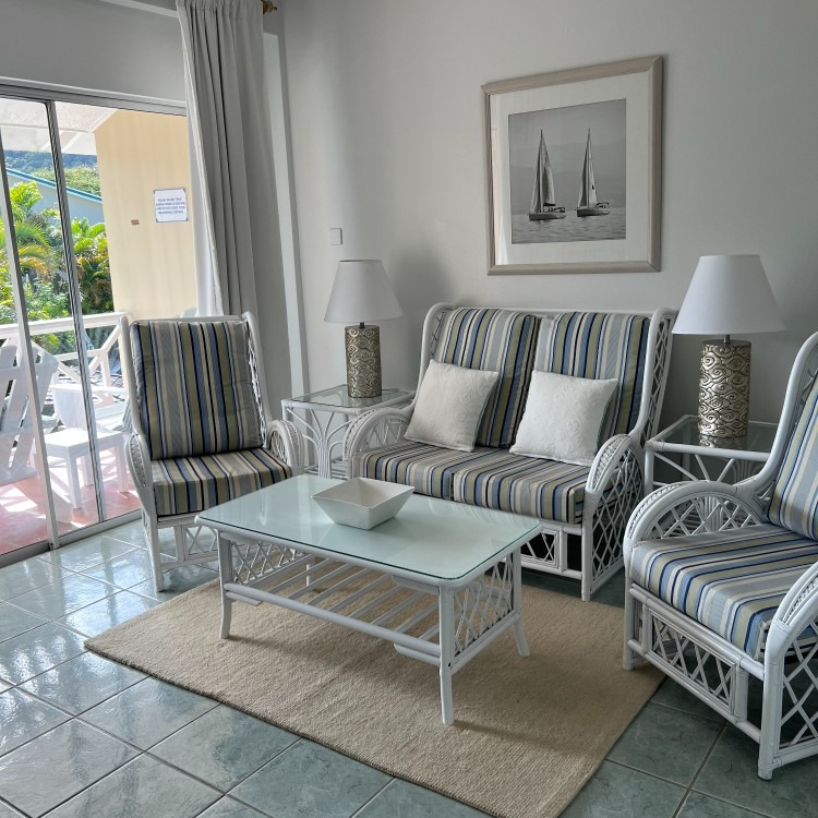 A living room with a couch and chairs and a coffee table