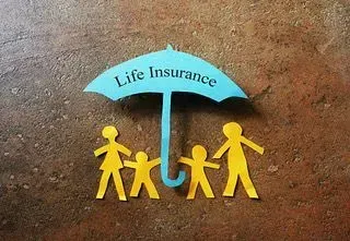 Blue umbrella labeled “Life Insurance” sheltering a yellow family icon on a brown background