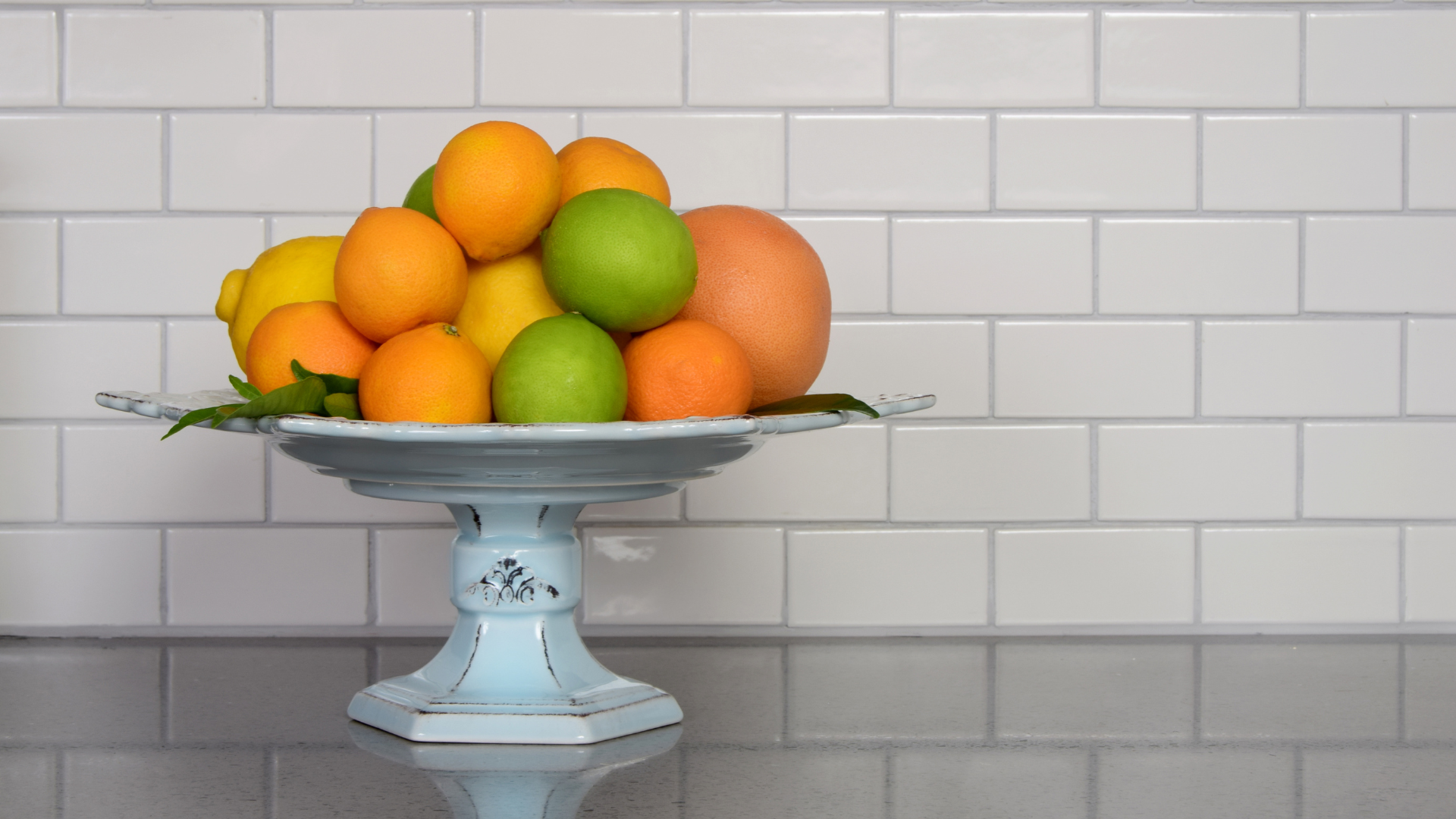 A bowl of fruit is sitting on a counter.