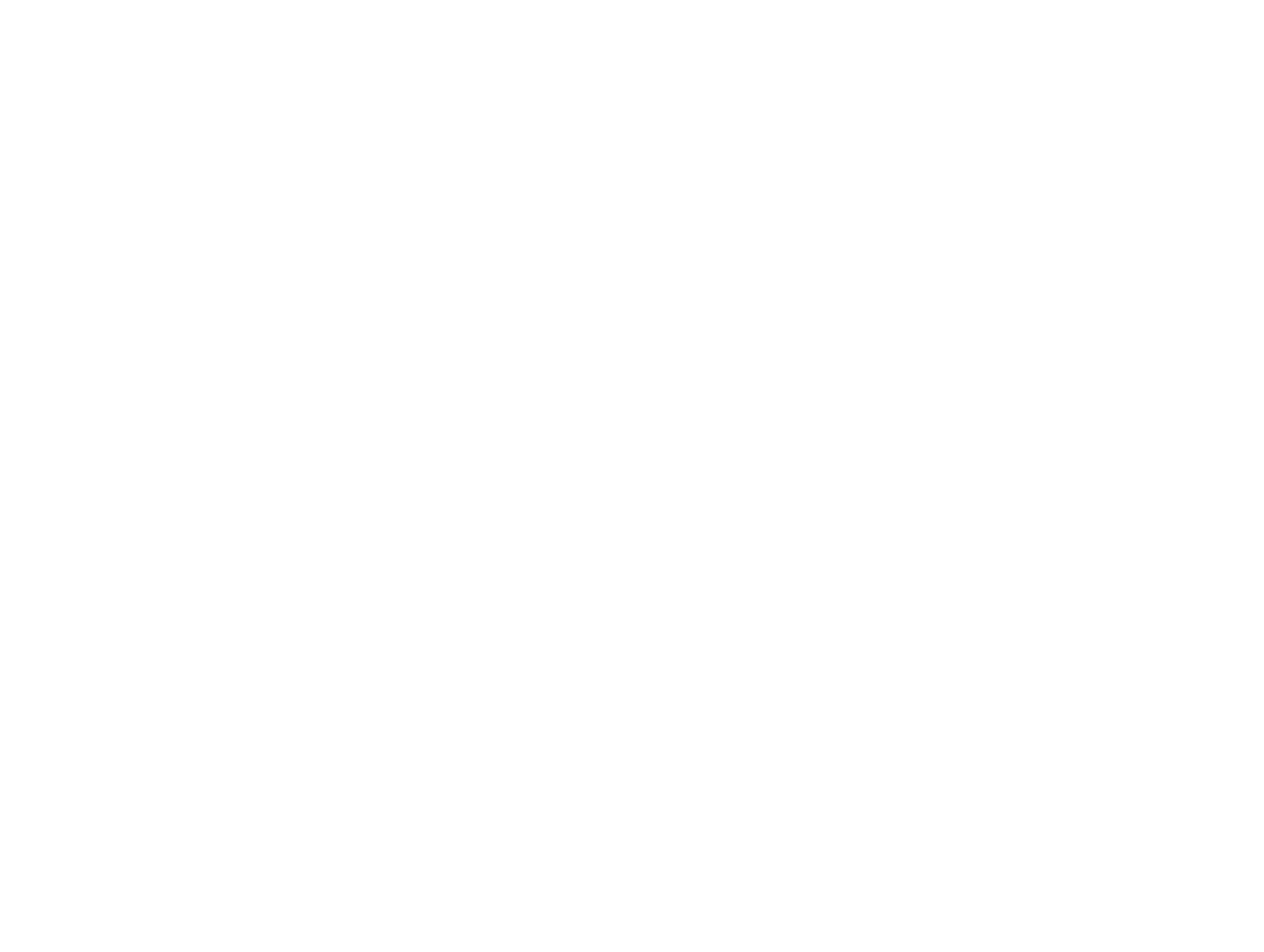 A young person holding a camera on a tripod, standing on a beach with the ocean and a cloudy sky in the background.