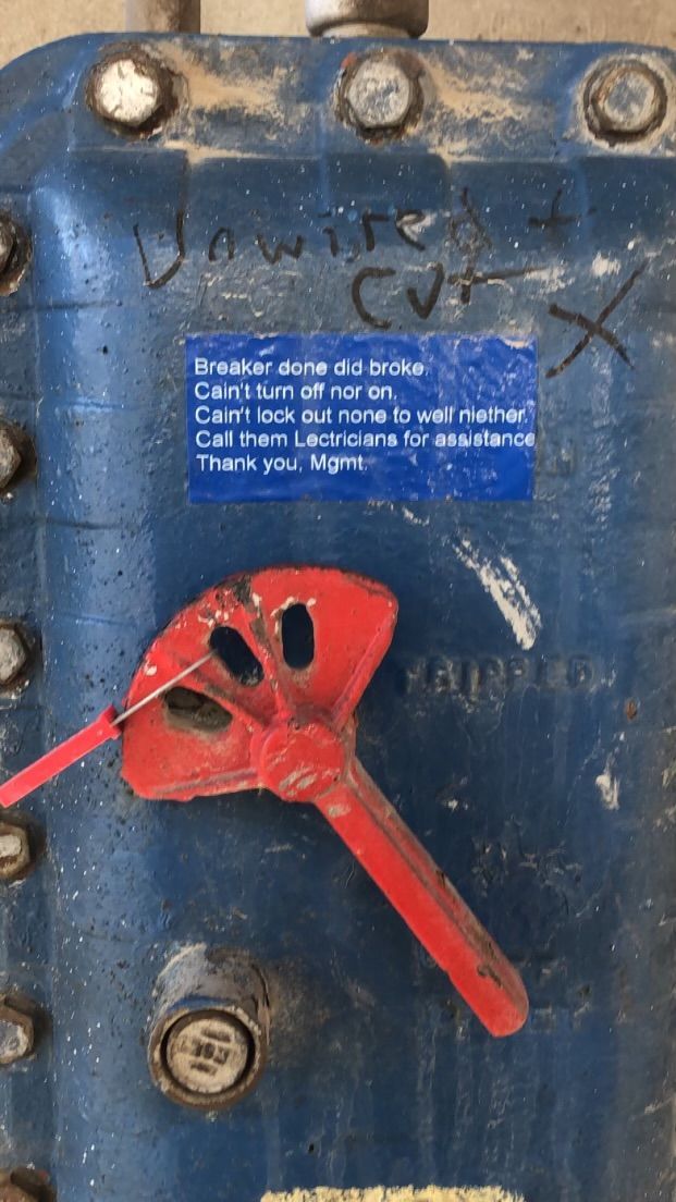 A blue box with a red handle and a blue sticker on it.