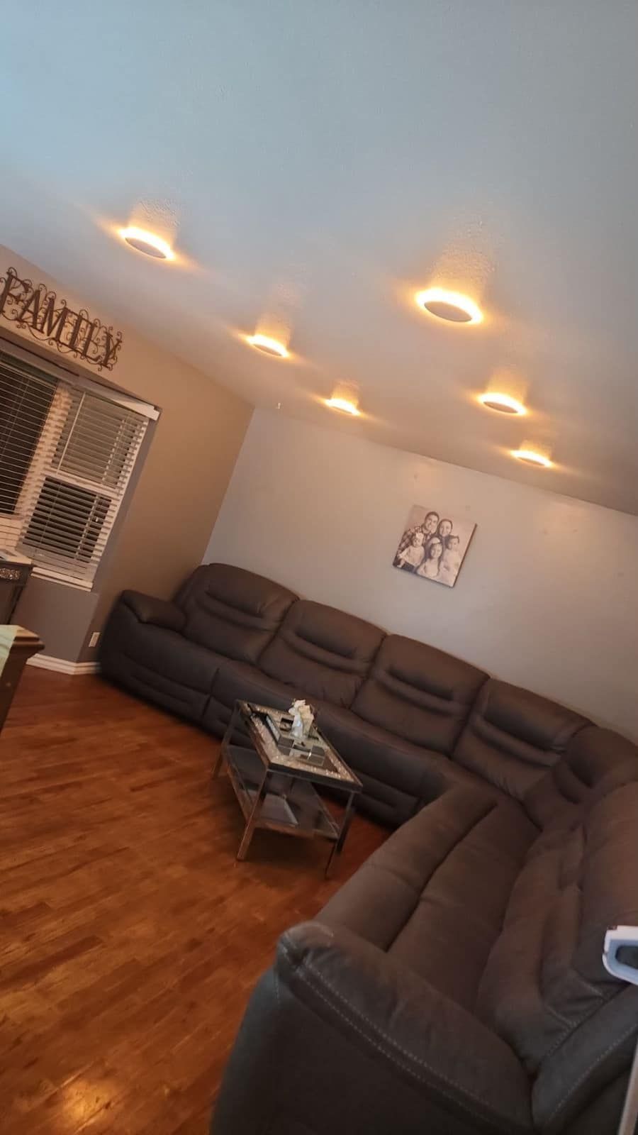 A living room with a large sectional couch and a coffee table.