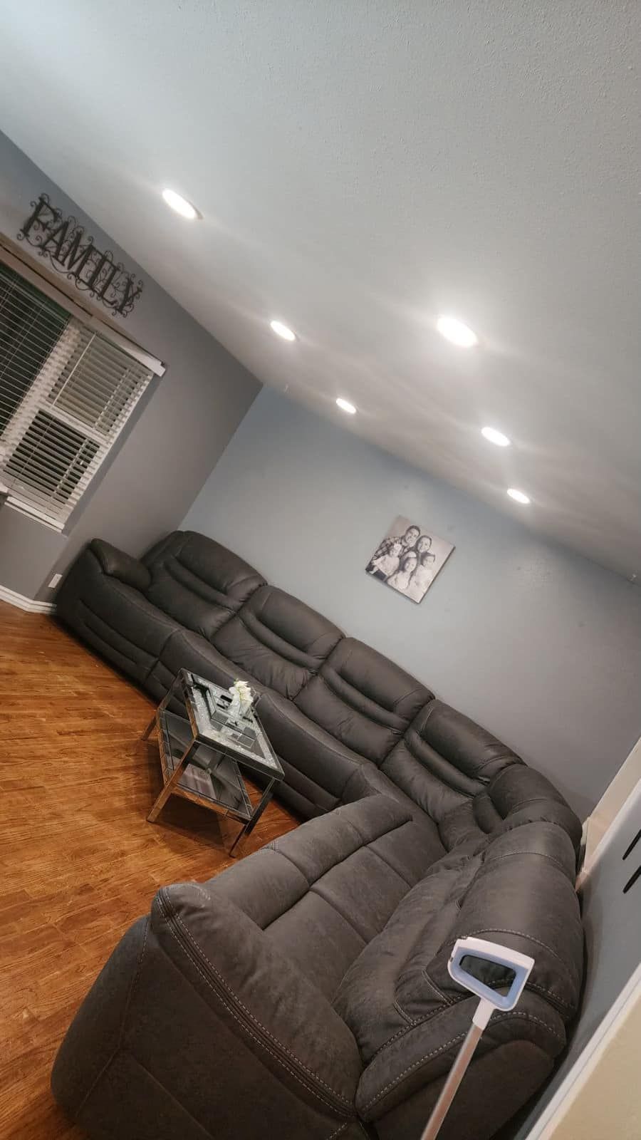 A living room with a large sectional couch and a coffee table.