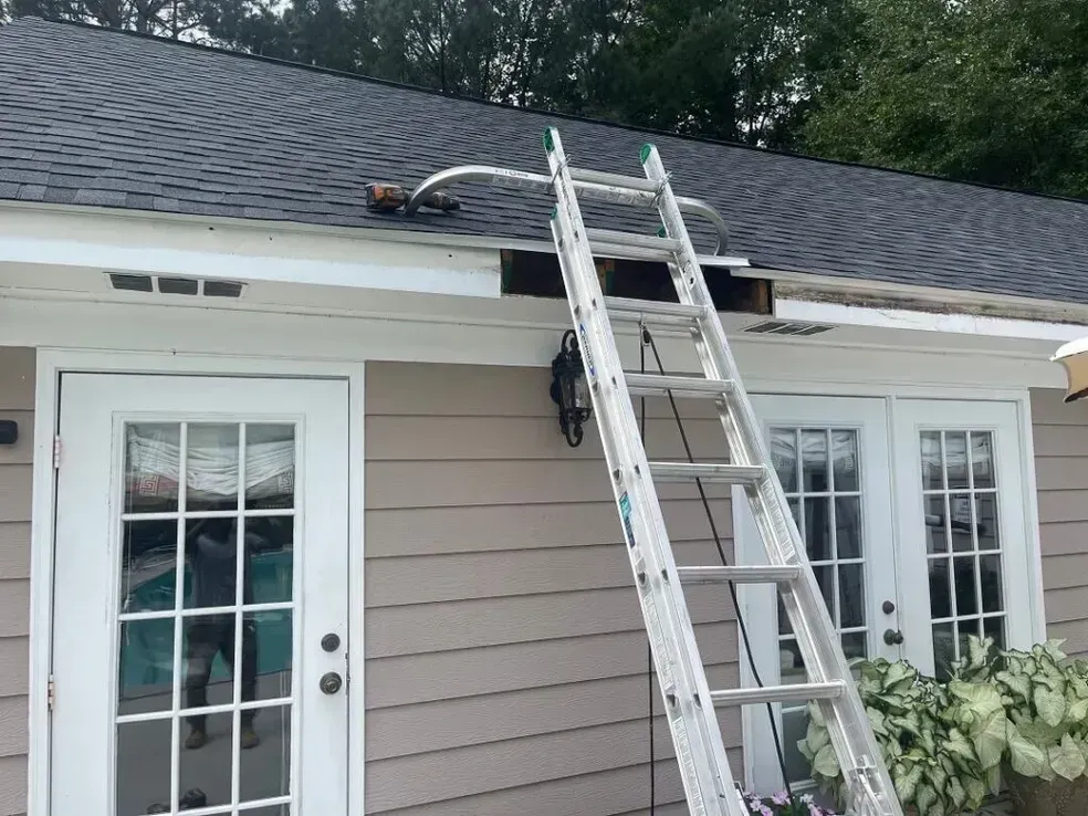 A ladder is attached to the side of a house.