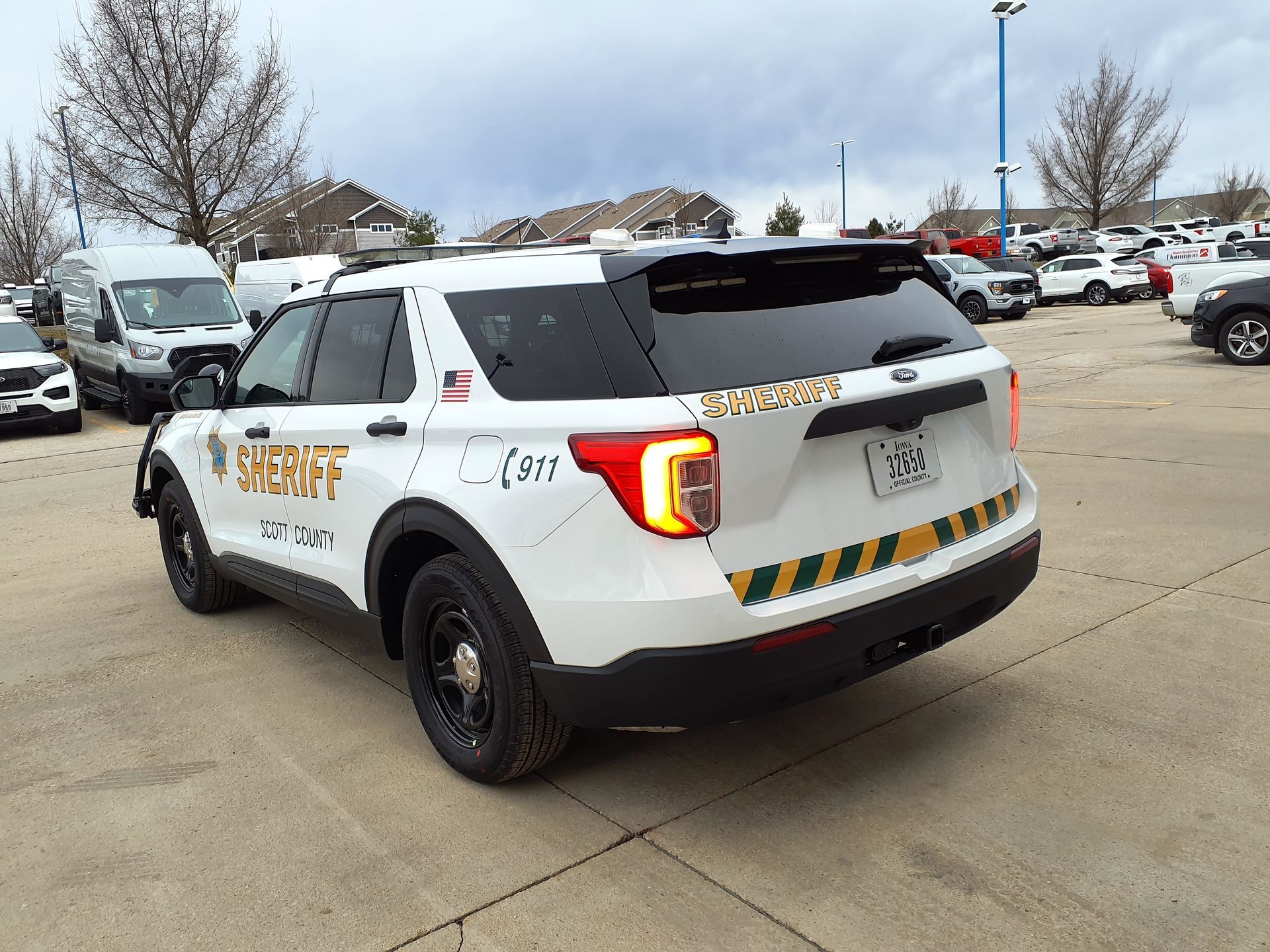 A white sheriff 's car is parked in a parking lot.