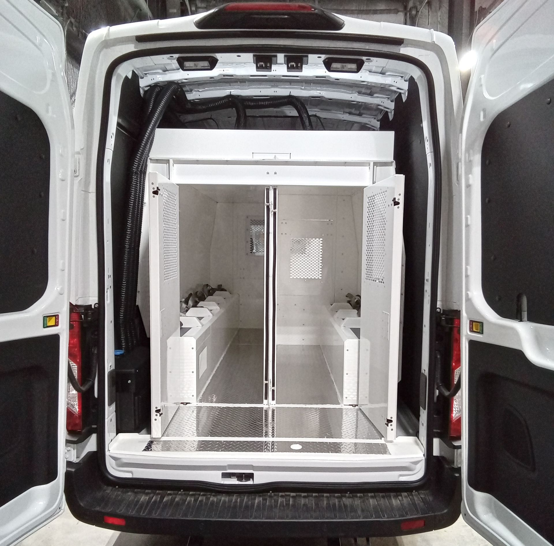 The back of a white van with the doors open