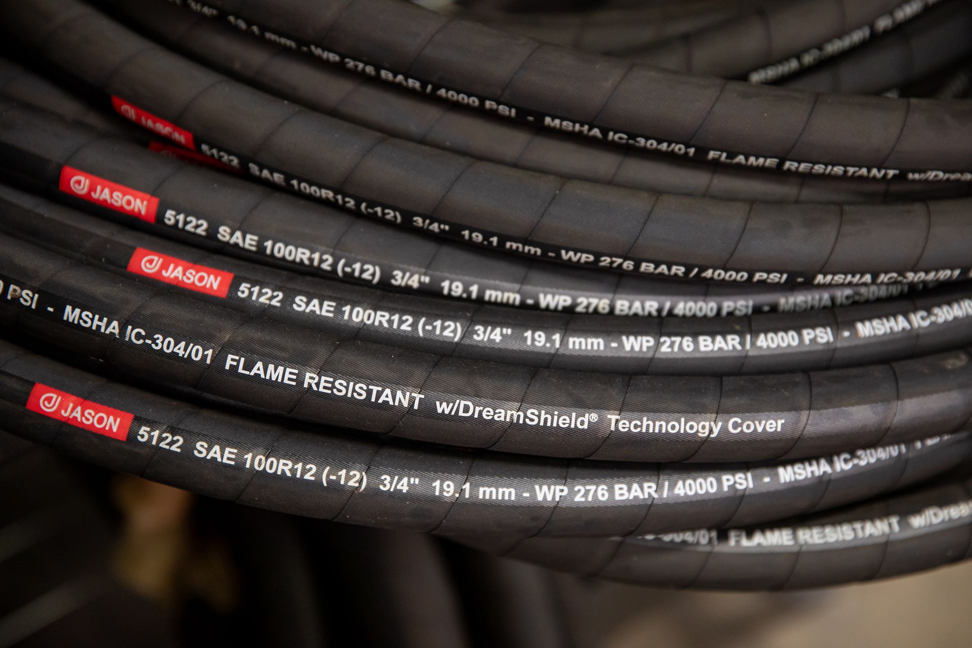 A close up of an industrial hose that says flame resistant on it