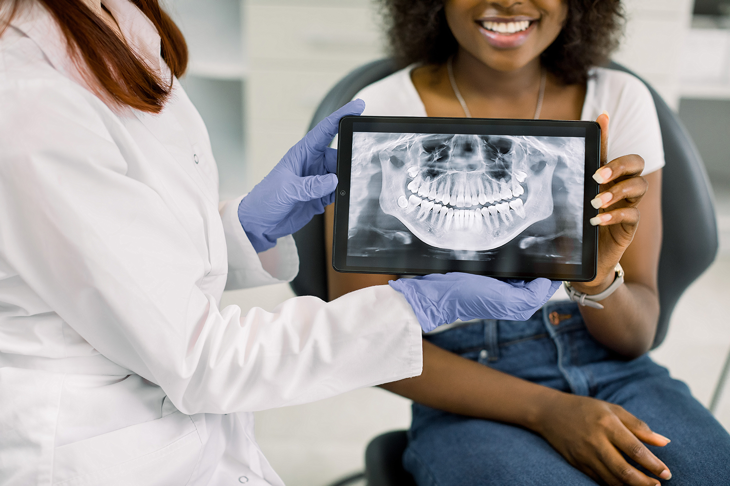 women in glasses pictured smiling outside after getting a digital radiograph
