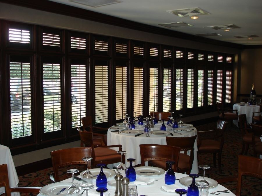 Drapes and Wood Blinds Installed in the Living Room — Window Treatments Showroom in Destin, FL
