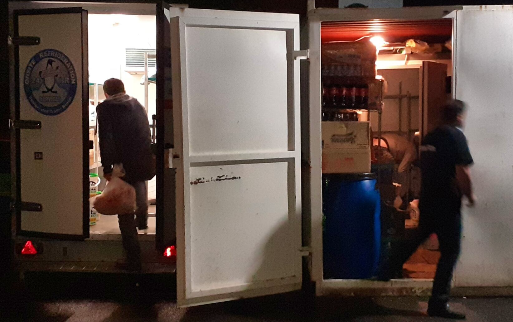 Coldroom breakdown showing people transferring stock to a freezer trailer