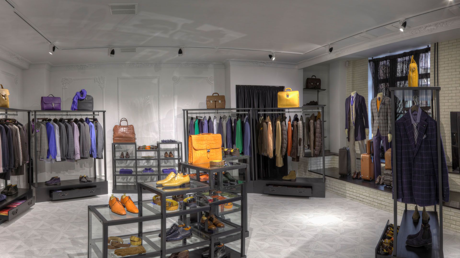 A clothes store with a lot of clothes and shoes on display.