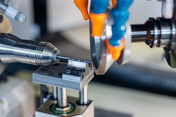 A person is using a machine to cut a piece of metal.