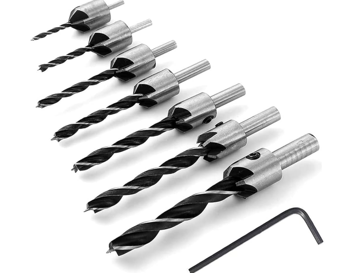 A set of drill bits and a wrench on a white background