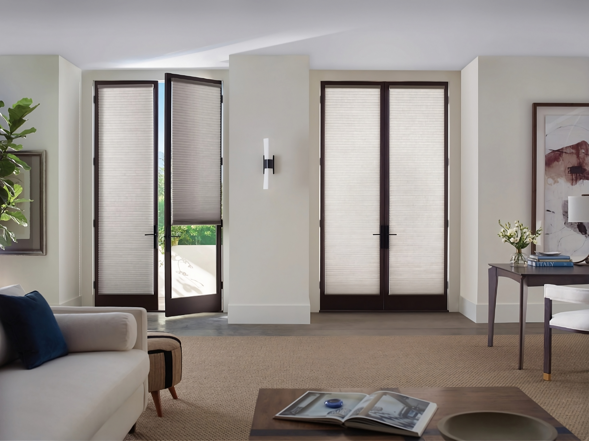 Hunter Douglas Duette® Cellular Shades on French doors leading outside from a modern living room 