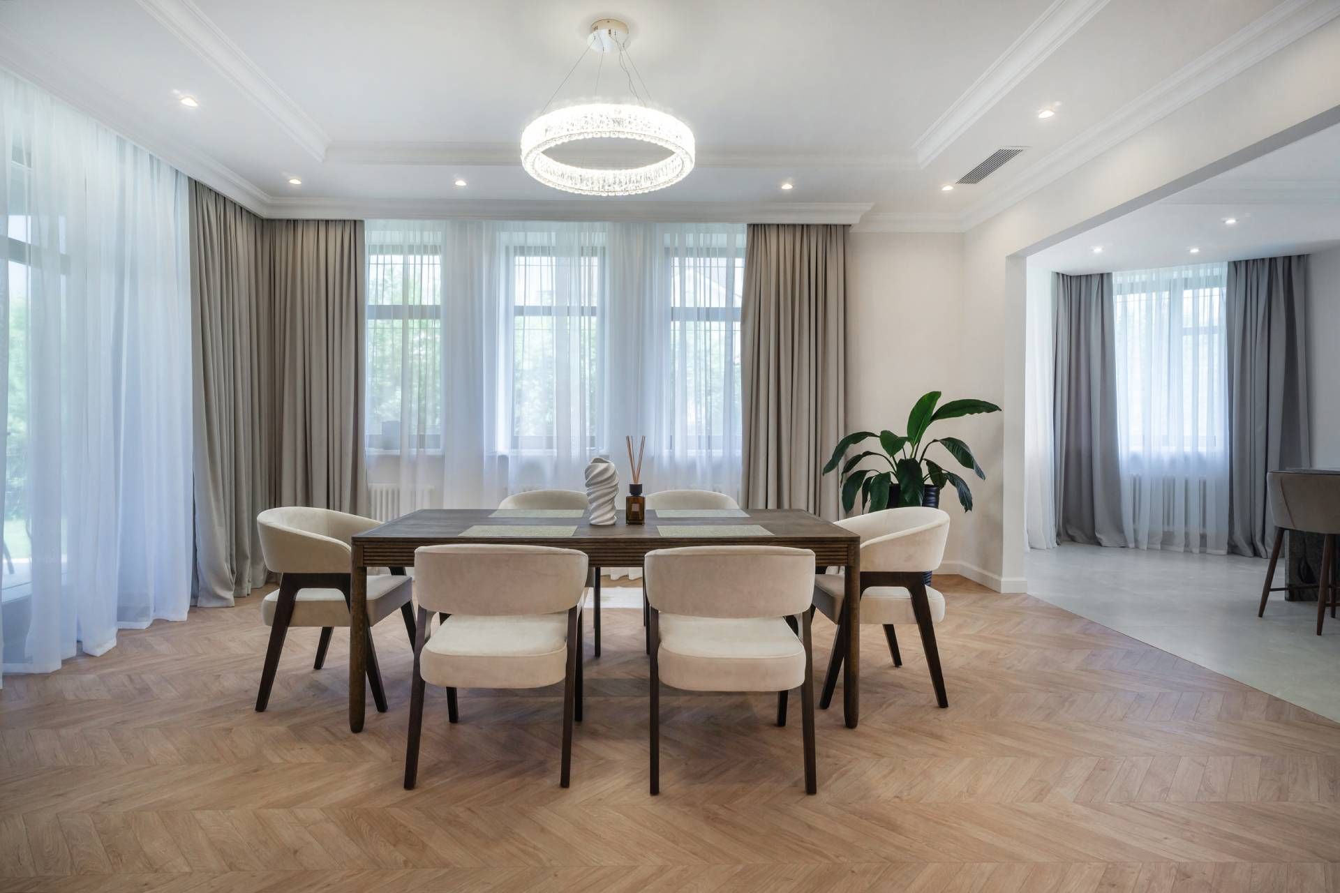 Newly layered drapes to refresh window coverings in a home's modern and chic dining room 