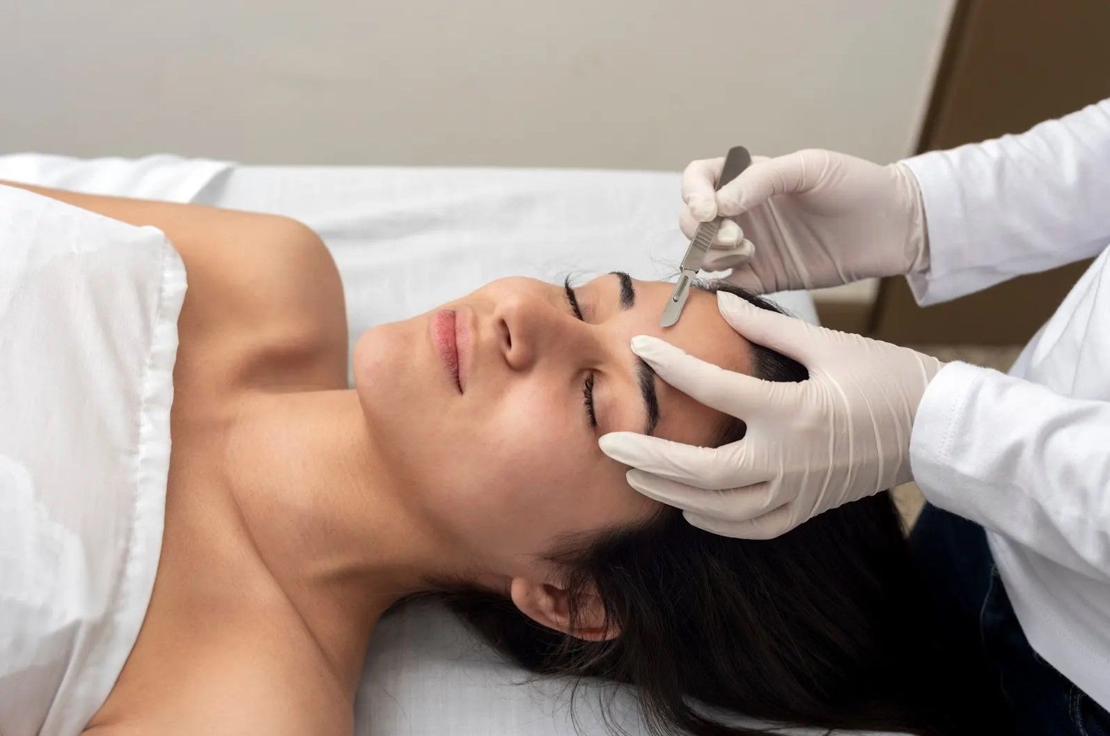 A woman is getting a facial treatment at a beauty salon.