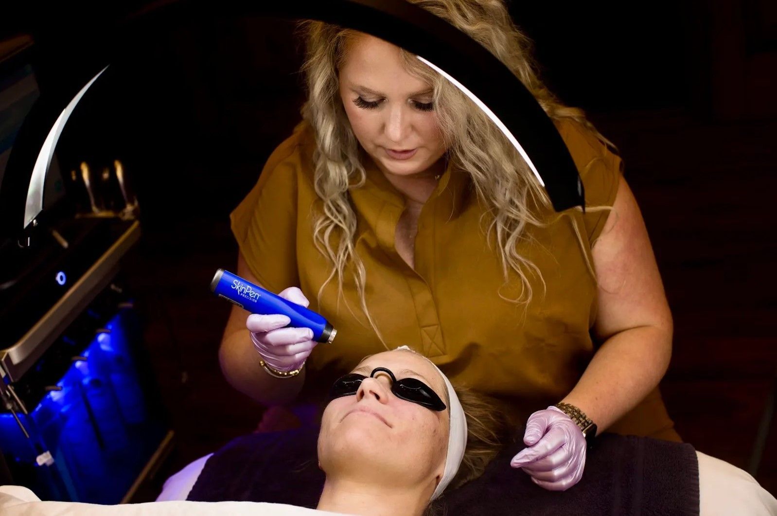 A woman is getting a laser treatment on her face.