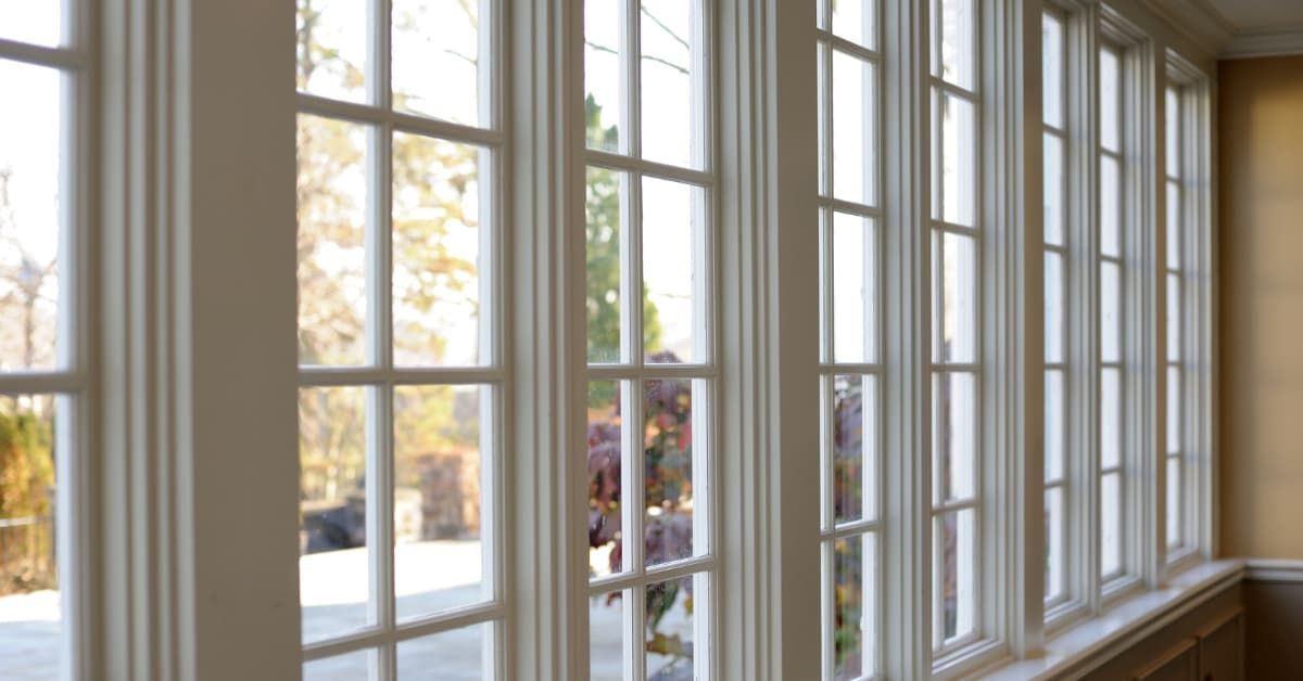 A row of large, white energy-efficient windows with multiple panes.