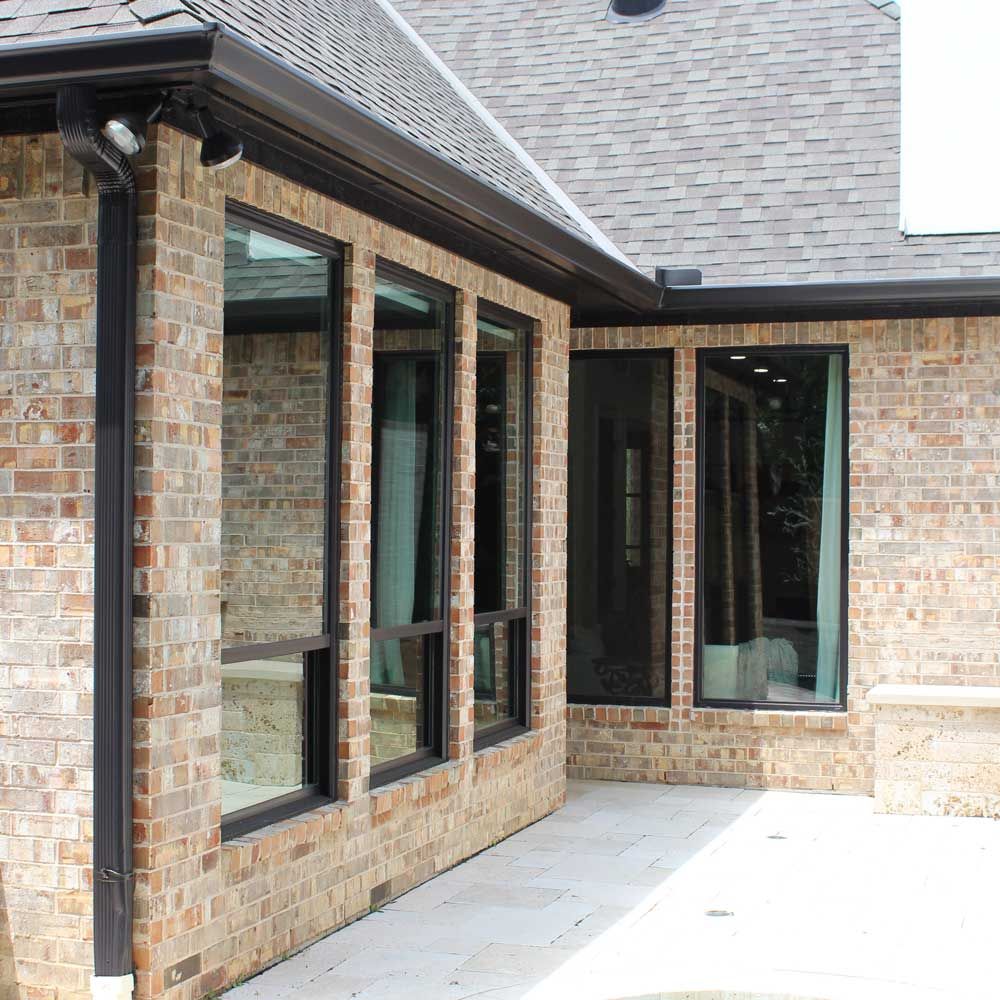 A brick house with a lot of windows on it