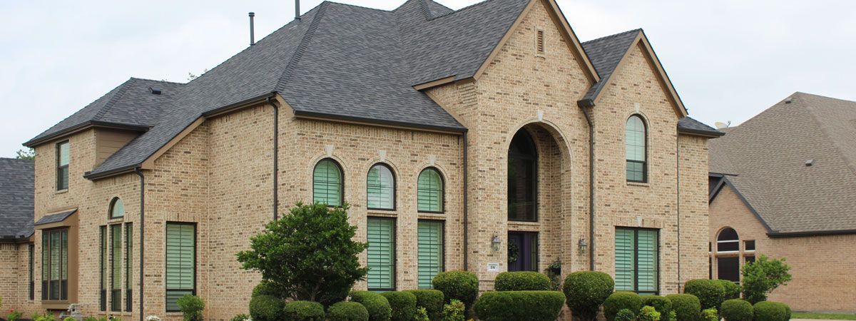 A large brick house with arched windows