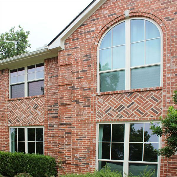 A large red brick house with arched windows