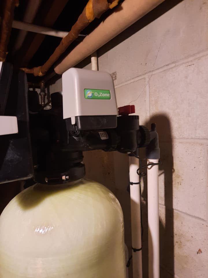 a water filter is attached to a wall in a basement