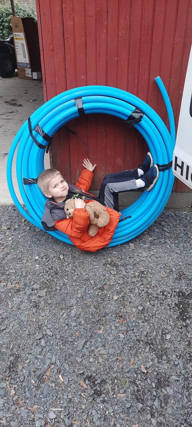 One of my sons lying on one hose pipe my favorite helper