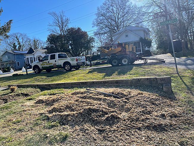 A couple of trucks parked in front of a house.