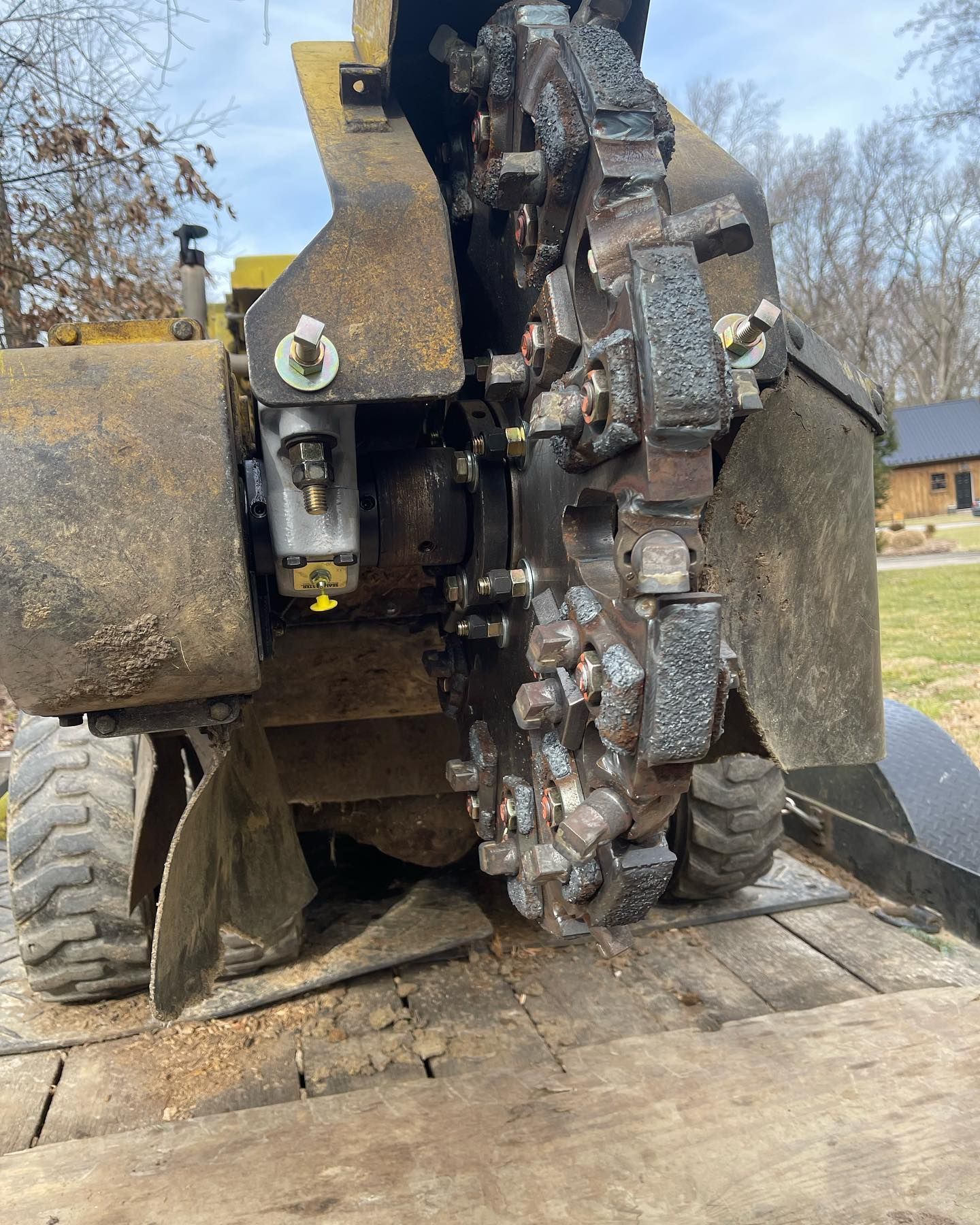 A large machine is sitting on top of a wooden platform.
