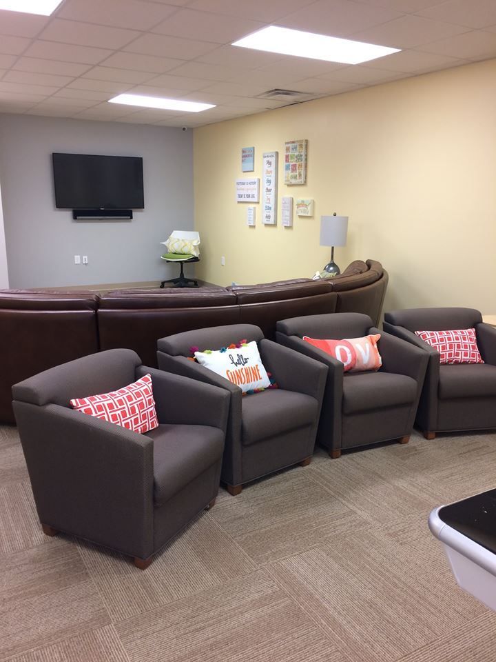 A living room with a lot of chairs and a couch