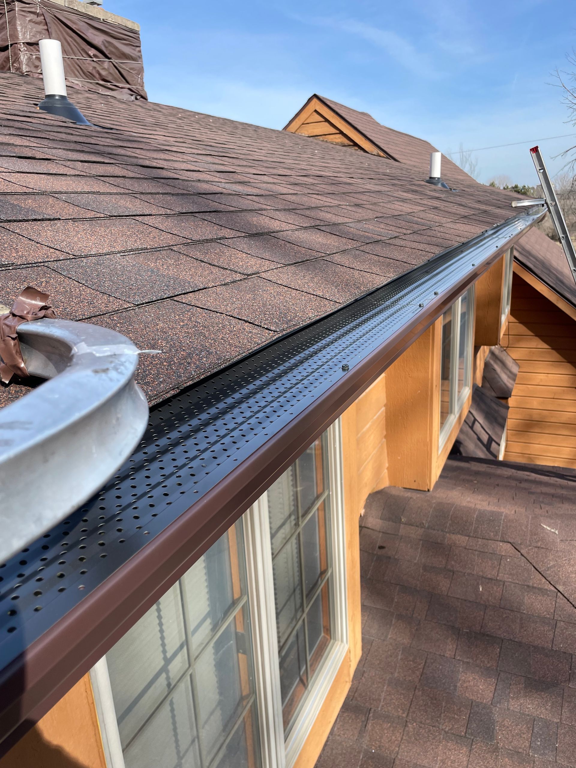 A house with a gutter on the side of it