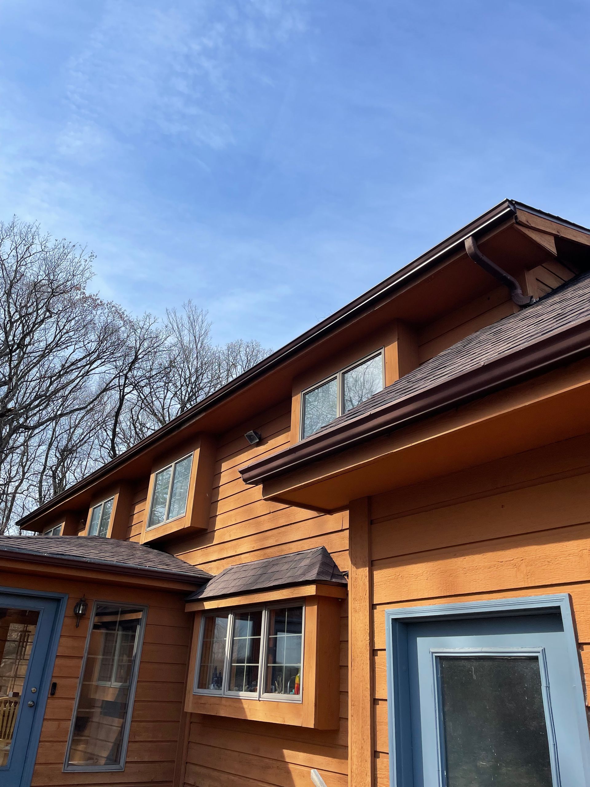 A house with a lot of windows and a blue door