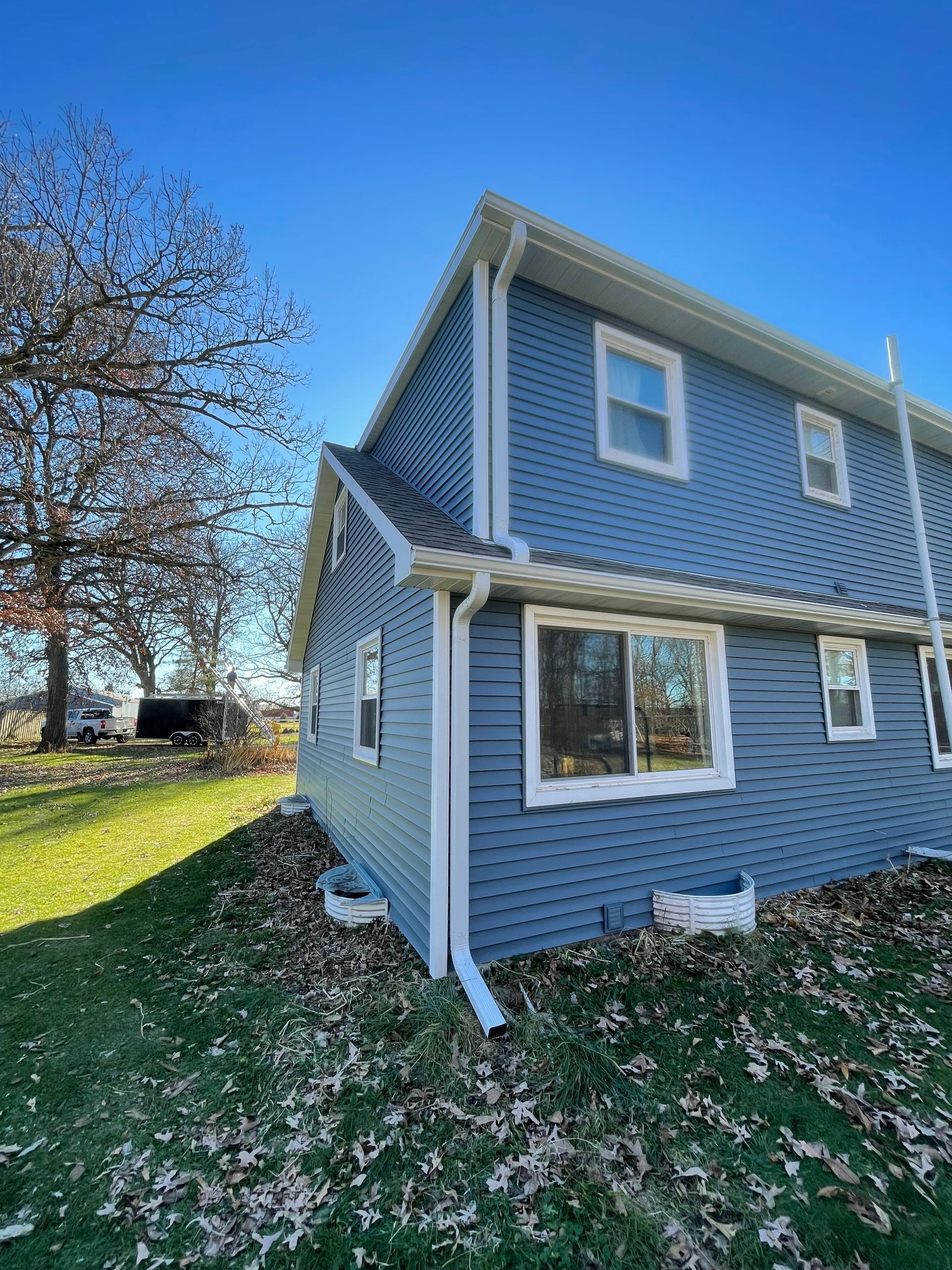 new gutters on blue sided home in Madison, Wisconsin