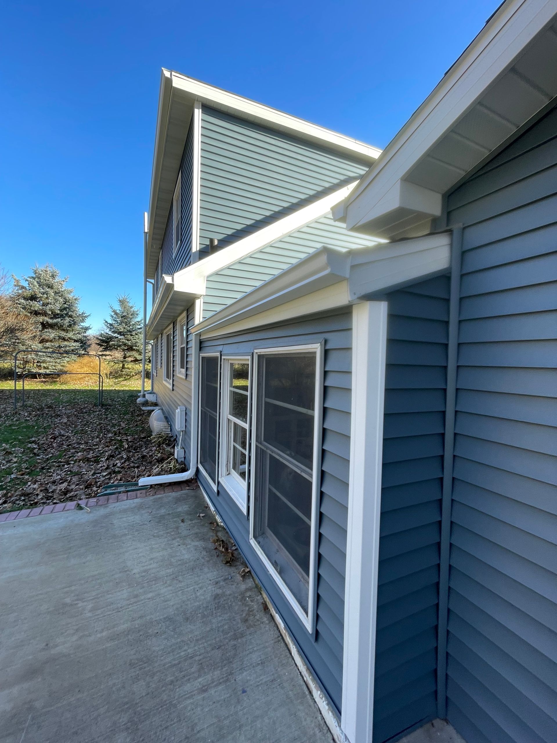 The side of a house with a blue siding and white trim