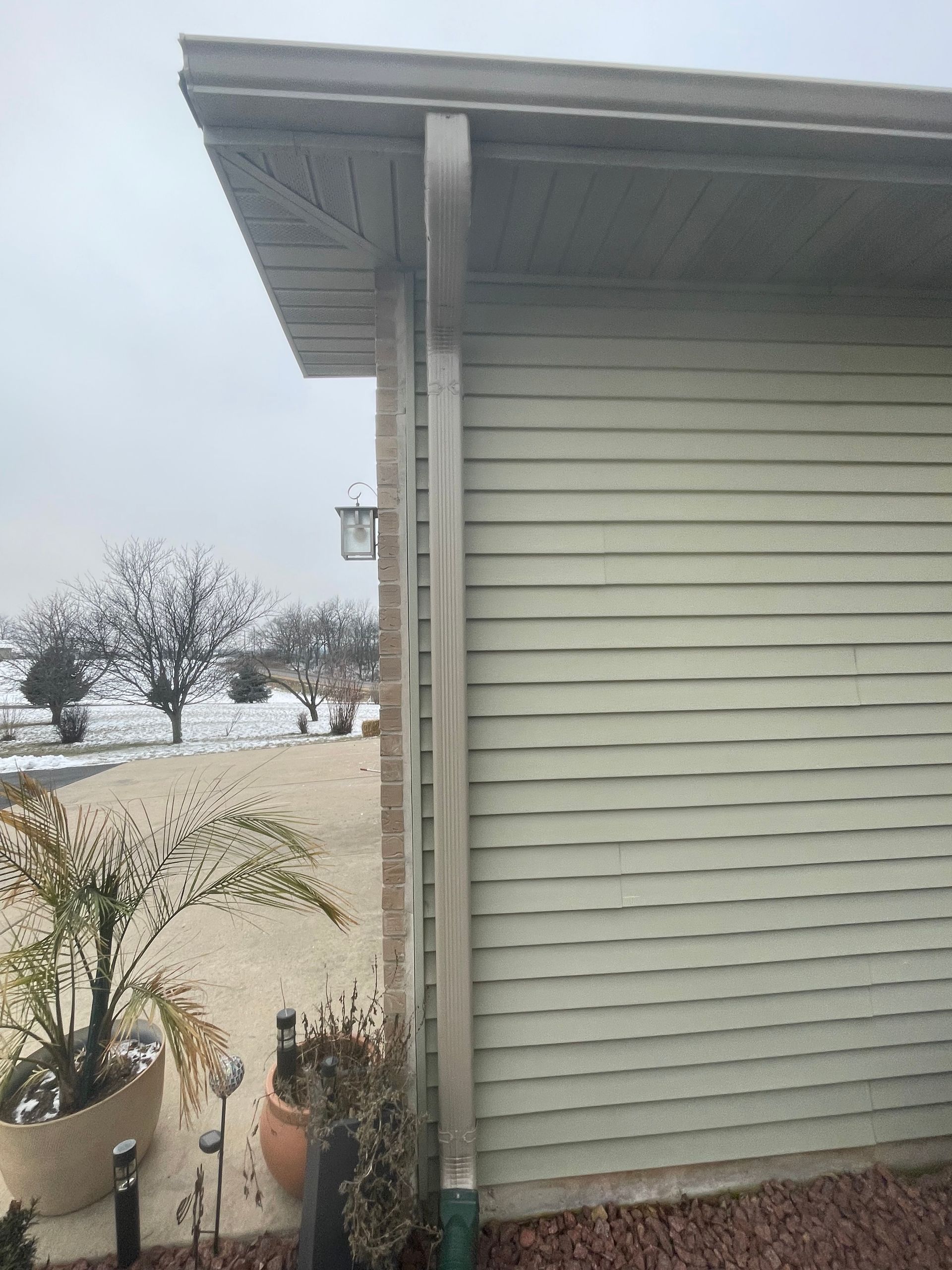 A house with a gutter on the side of it.