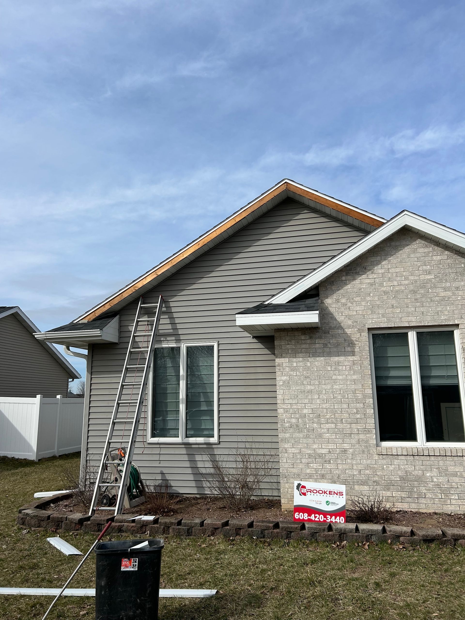 A house with a ladder sitting on the side of it.