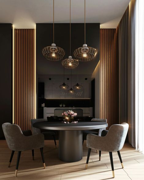 Dining room with round table, four chairs, and three pendant lights. Dark walls, wood paneling, and sheer curtains.