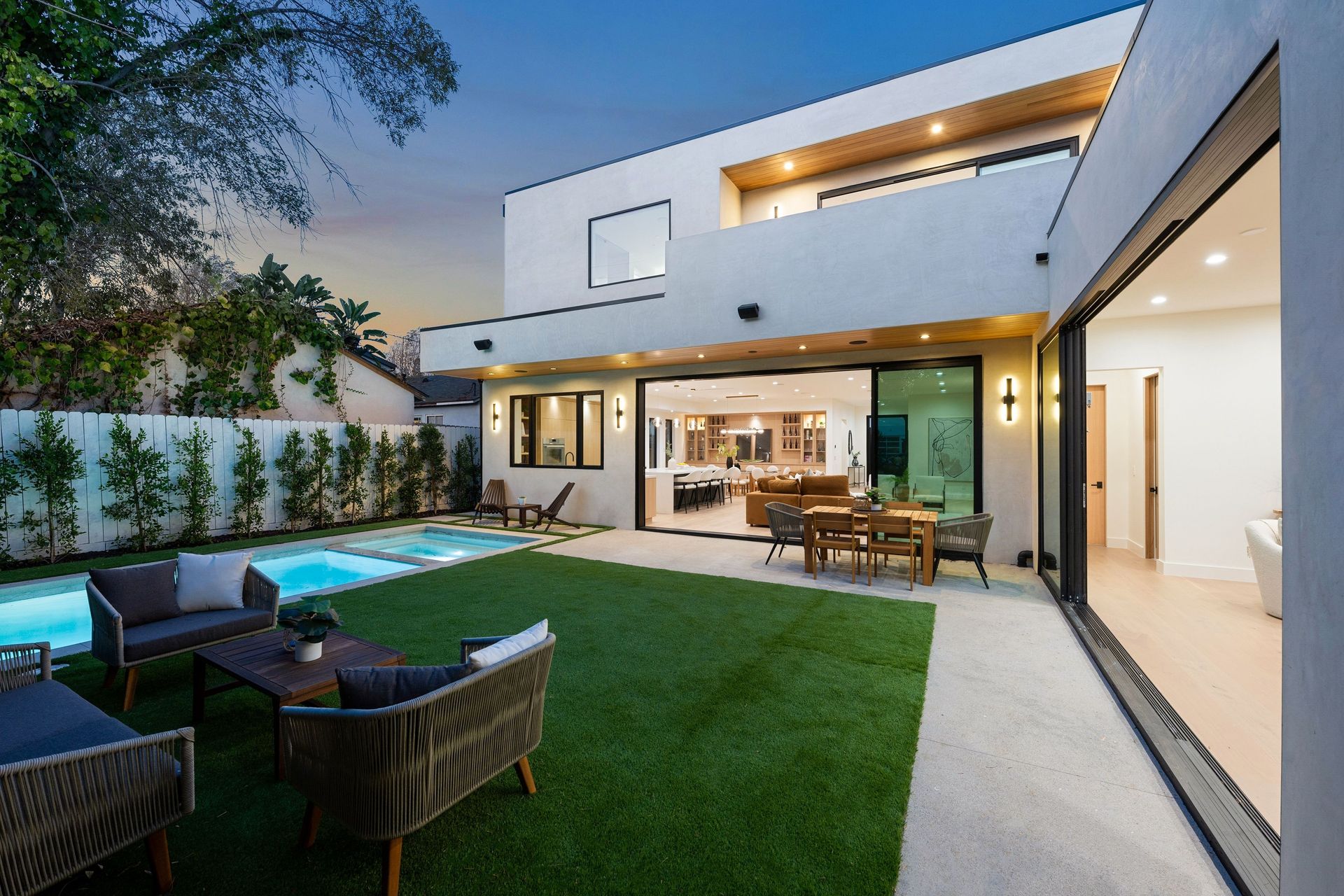 Modern home exterior with pool and backyard patio.