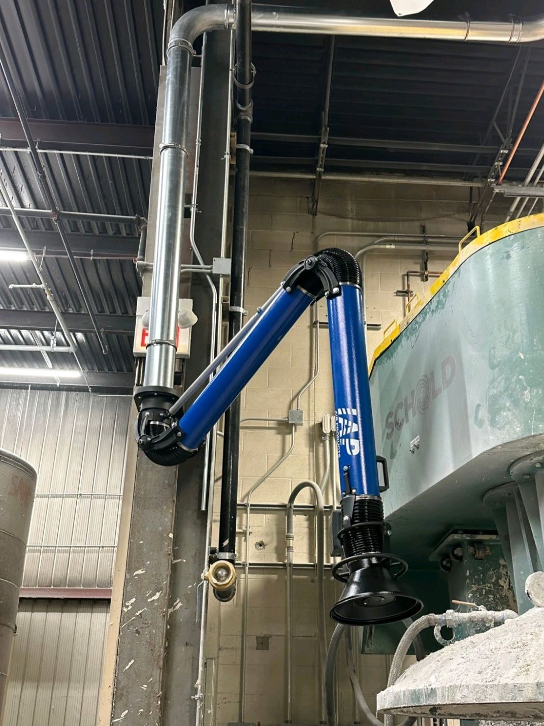 Extraction fume arms installed in manufacturing plant