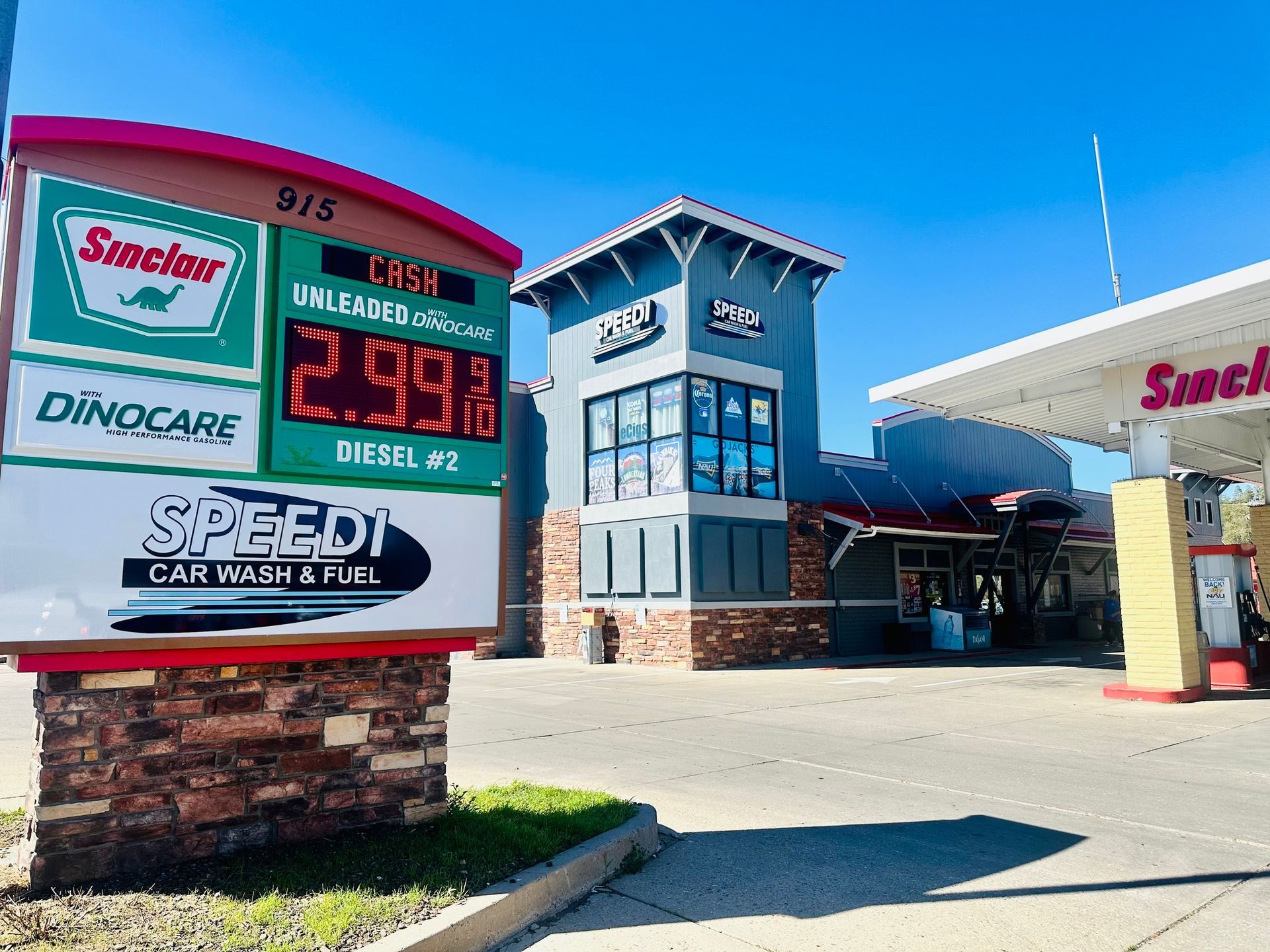 Gas station with a digital price sign, a car wash, and a Sinclair logo.