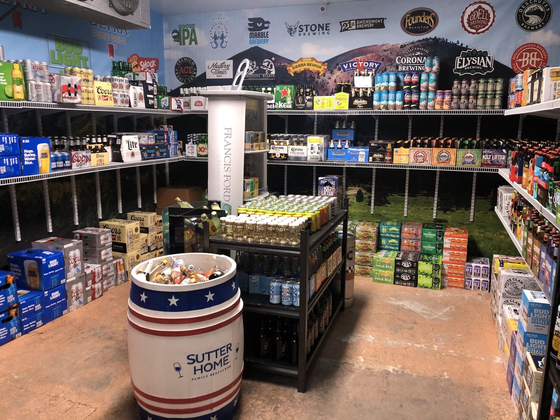 Inside a beer store with shelves stocked with various beer brands. A barrel and display stand are in the foreground.
