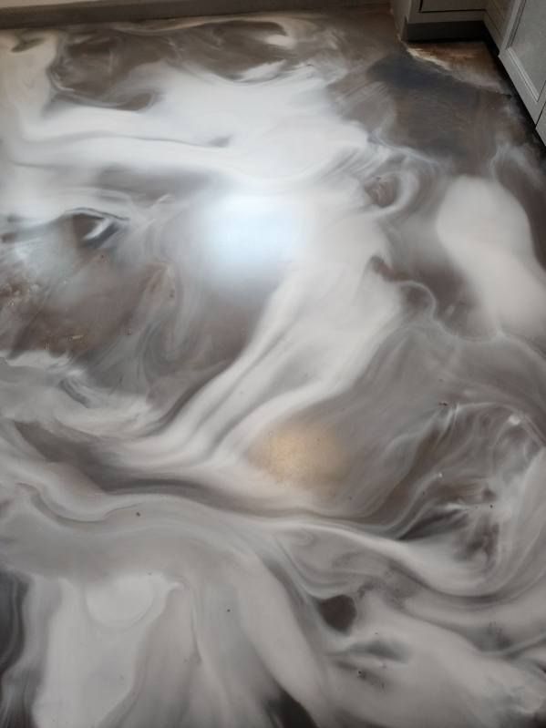A close up of a marble floor in a kitchen.